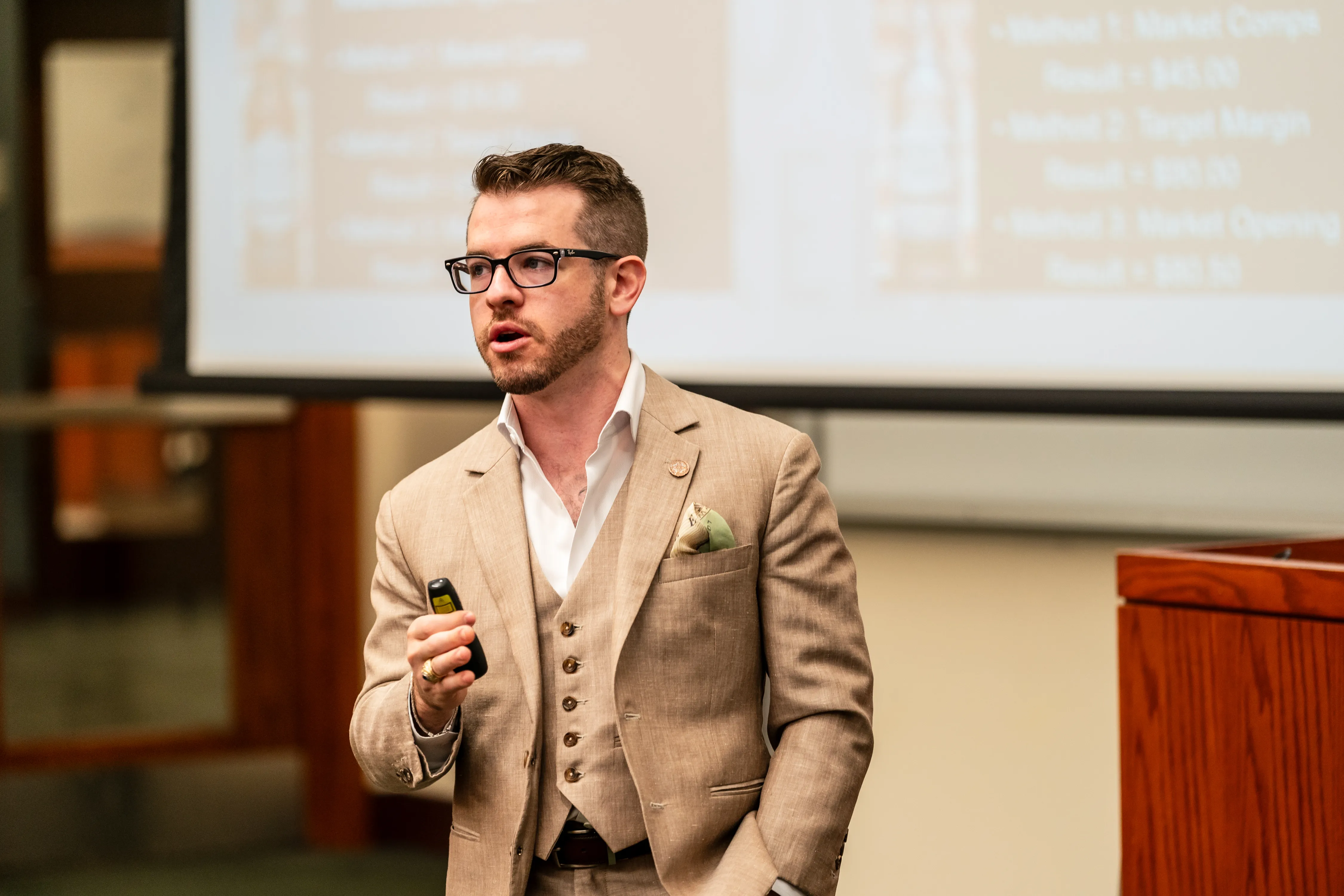 Brandon Karpf presenting to a packed auditorium