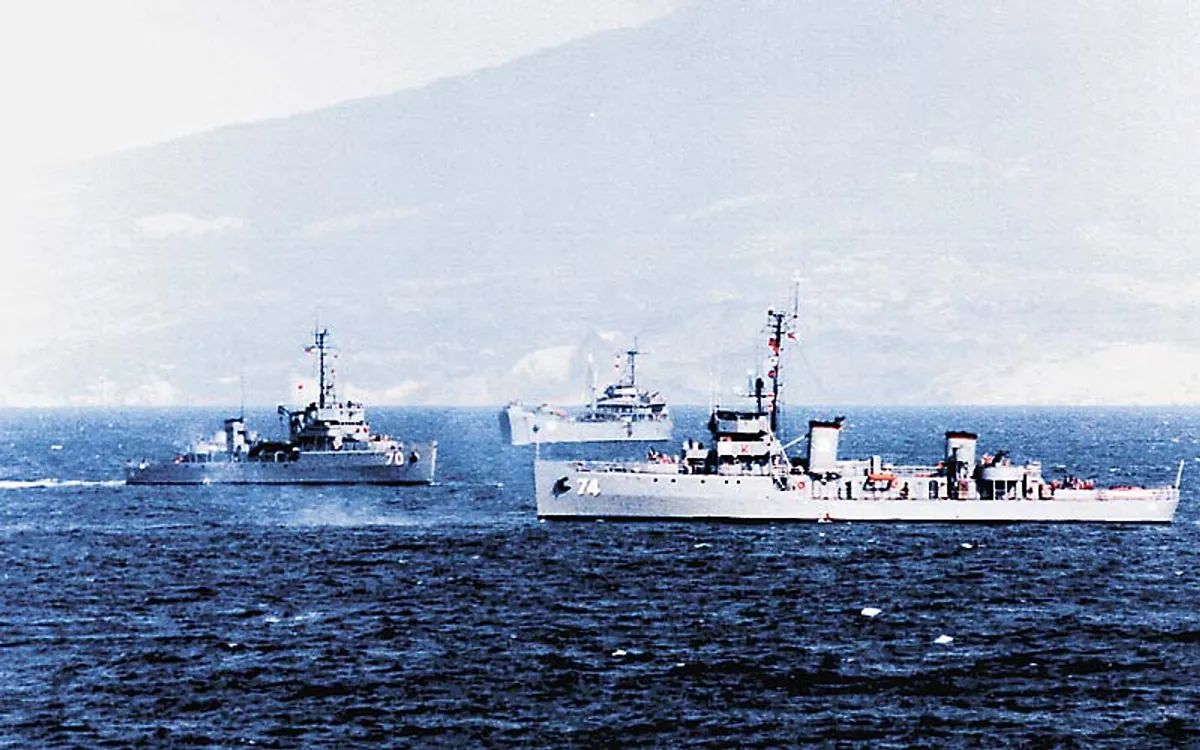 BRP Rizal (PS-74) and BRP Quezon (PS-70) of the Philippine Navy underway off a mountainous coastline.
