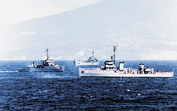 BRP Rizal (PS-74) and BRP Quezon (PS-70) of the Philippine Navy underway off a mountainous coastline.