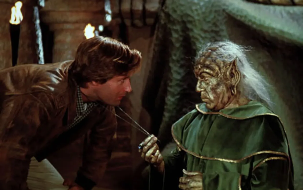 Yogurt, the ancient and wise mystic from Spaceballs, clutching his cane in a dark cave—reluctant guide to orbital economics.