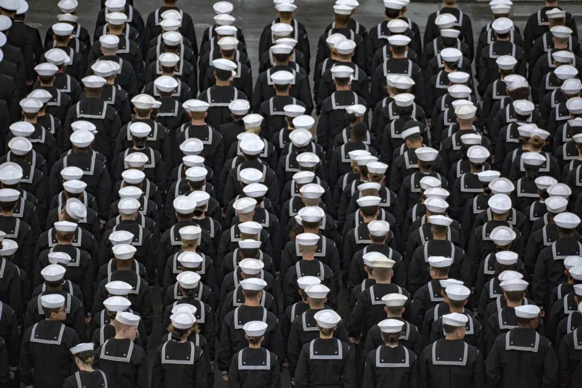 Sailors disinfecting a Navy workspace during the early COVID-19 response.