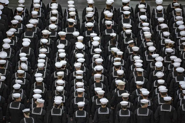 Sailors disinfecting a Navy workspace during the early COVID-19 response.